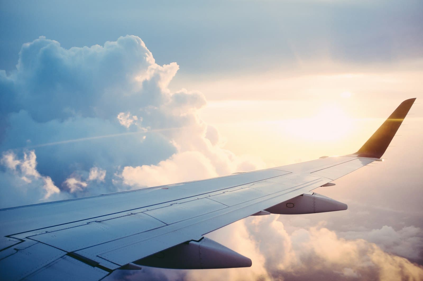 An aircraft wing above a layer of cloud